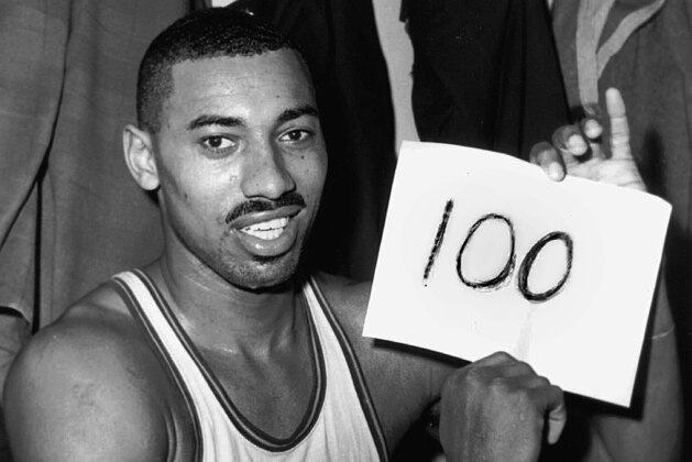 FILE - In this March 2, 1962 file photo, Wilt Chamberlain of the Philadelphia Warriors holds a sign reading