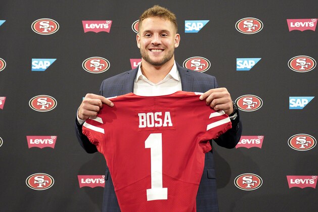 San Francisco 49ers first-round pick Nick Bosa poses with his jersey during an NFL football news conference, Friday, April 26, 2019, in Santa Clara, Calif. (AP Photo/Tony Avelar )