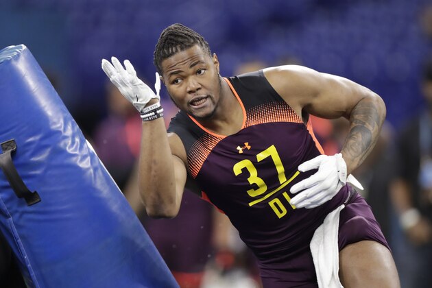 Michigan defensive lineman Rashan Gary runs a drill at the NFL football scouting combine in Indianapolis, Sunday, March 3, 2019. (AP Photo/Michael Conroy)