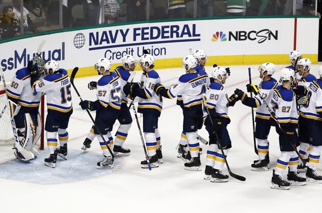 St. Louis Blues' Jordan Binnington (50) is congratulated by Robby Fabbri (15) and the rest of the team after their win against the Dallas Stars in Game 3 of an NHL second-round hockey playoff series in Dallas, Monday, April 29, 2019. (AP Photo/Tony Gutierrez)