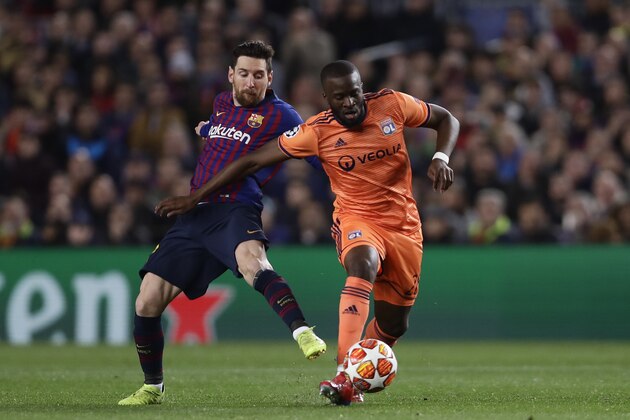 Barcelona forward Lionel Messi, left, fights for the ball with Lyon midfielder Tanguy Ndombele during the Champions League round of 16, 2nd leg, soccer match between FC Barcelona and Olympique Lyon at the Camp Nou stadium in Barcelona, Spain, Wednesday, March 13, 2019. (AP Photo/Manu Fernandez)
