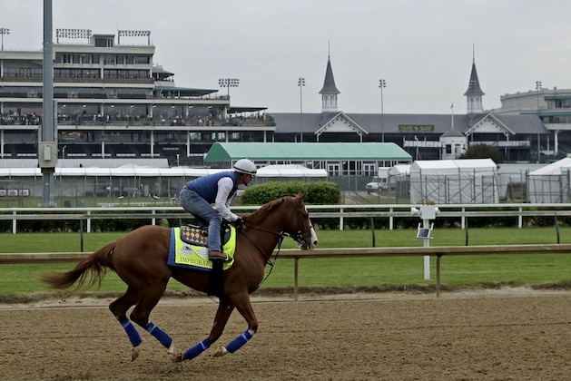 Kentucky Derby hopeful Improbable is ridden during a workout at Churchill Downs Tuesday, April 30, 2019, in Louisville, Ky. The 145th running of the Kentucky Derby is scheduled for Saturday, May 4. (AP Photo/Charlie Riedel)