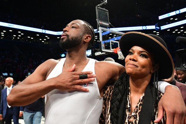 NEW YORK, NEW YORK - APRIL 10: Dwyane Wade #3 of the Miami Heat thanks the fans with his wife Gabrielle Union after the game against the Brooklyn Nets at Barclays Center on April 10, 2019 in the Brooklyn borough of New York City. This was Wade's last NBA game before retirement. NOTE TO USER: User expressly acknowledges and agrees that, by downloading and or using this photograph, User is consenting to the terms and conditions of the Getty Images License Agreement.(Photo by Sarah Stier/Getty Images)