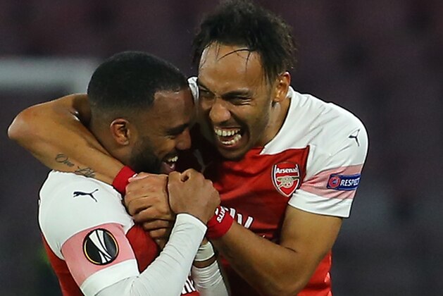Arsenal's French striker Alexandre Lacazette (L) celebrates with Arsenal's Gabonese striker Pierre-Emerick Aubameyang after opening the scoring during the UEFA Europa League quarter-final second leg football match Napoli vs Arsenal on April 18, 2019 at the San Paolo stadium in Naples. (Photo by Carlo Hermann / AFP)        (Photo credit should read CARLO HERMANN/AFP/Getty Images)