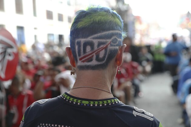 A fan shows off the NFL 100 logo shaved and dyed in the back of their head during the sixth round of the NFL football draft, Saturday, April 27, 2019, in Nashville, Tenn. (AP Photo/Steve Luciano)