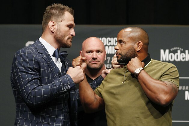 Stipe Miocic, left, and Daniel Cormier pose during a news conference for UFC 226, Thursday, July 5, 2018, in Las Vegas. The two are scheduled to fight in a heavyweight title fight Saturday in Las Vegas. (AP Photo/John Locher)