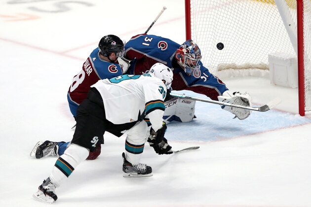 DENVER, COLORADO - APRIL 30: Logan Couture #39 of the San Jose Sharks scores a goal past Cale Makar #8 and goalie Philipp Grubauer #31 of the Colorado Avalanche in Game Three of the Western Conference Second Round during the 2019 NHL Stanley Cup Playoffs at the Pepsi Center on April 30, 2019 in Denver, Colorado. (Photo by Matthew Stockman/Getty Images)