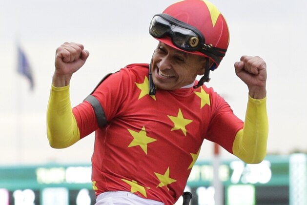 Jockey Mike Smith celebrates after guiding Justify to win the 150th running of the Belmont Stakes horse race and Triple Crown, Saturday, June 9, 2018, in Elmont, N.Y. (AP Photo/Frank Franklin II)