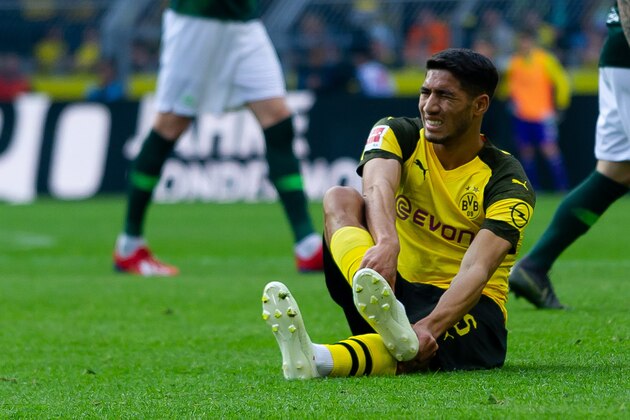 DORTMUND, GERMANY - MARCH 30: Achraf Hakimi of Borussia Dortmund is injured during the Bundesliga match between Borussia Dortmund and VfL Wolfsburg at Signal Iduna Park on March 30, 2019 in Dortmund, Germany. (Photo by TF-Images/Getty Images)
