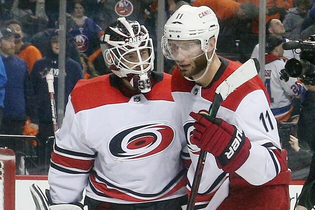 NEW YORK, NEW YORK - APRIL 28:Curtis McElhinney #35 and Jordan Staal #11 of the Carolina Hurricanes celebrate their 2-1 victory over the New York Islanders in Game Two of the Eastern Conference Second Round during the 2019 NHL Stanley Cup Playoffs at the Barclays Center on April 28, 2019 in the Brooklyn borough of New York City. (Photo by Bruce Bennett/Getty Images)
