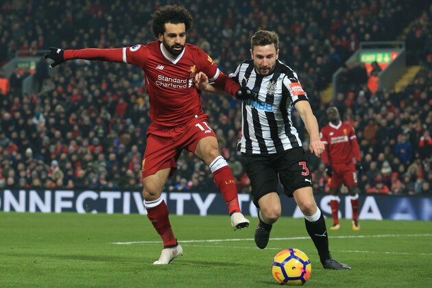 Newcastle United's Welsh defender Paul Dummett concedes a corner as Liverpool's Egyptian midfielder Mohamed Salah (L) attacks during the English Premier League football match between Liverpool and Newcastle at Anfield in Liverpool, north west England on March 3, 2018. / AFP PHOTO / Lindsey PARNABY / RESTRICTED TO EDITORIAL USE. No use with unauthorized audio, video, data, fixture lists, club/league logos or 'live' services. Online in-match use limited to 75 images, no video emulation. No use in betting, games or single club/league/player publications.  /         (Photo credit should read LINDSEY PARNABY/AFP/Getty Images)