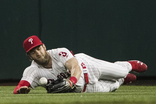 Philadelphia Phillies right fielder Bryce Harper drops a ball hit by the Detroit Tigers' Niko Goodrum during the eighth inning of a baseball game, Tuesday, April 30, 2019, in Philadelphia. The Tigers won 3-1. (AP Photo/Matt Rourke)