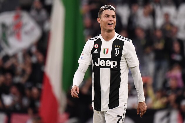 Juventus' Portuguese forward Cristiano Ronaldo, his head covered in foam, acknowledges fans and celebrates after Juventus secured its 8th consecutive Italian 2018/19