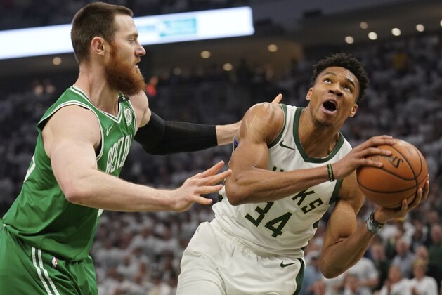 Milwaukee Bucks' Giannis Antetokounmpo looks to shoot past Boston Celtics' Aron Baynes during the first half of Game 2 of a second round NBA basketball playoff series Tuesday, April 30, 2019, in Milwaukee. (AP Photo/Morry Gash)
