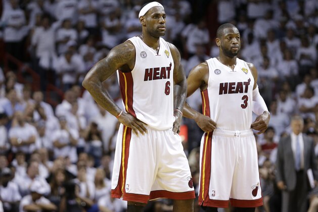 Miami Heat small forward LeBron James (6) and Miami Heat shooting guard Dwyane Wade (3) reacts in the closing moments of the second half of Game 1 of the NBA Finals basketball game against the San Antonio Spurs, Thursday, June 6, 2013 in Miami. (AP Photo/Lynne Sladky)