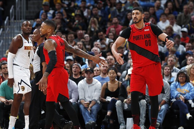 Portland Trail Blazers guard Damian Lillard, left, congratulates center Enes Kanter after his basket against the Denver Nuggets during the first half of Game 2 of an NBA basketball second-round playoff series Wednesday, May 1, 2019, in Denver. (AP Photo/David Zalubowski)