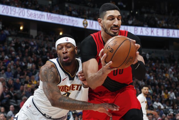 Denver Nuggets forward Torrey Craig, left, runs into Portland Trail Blazers center Enes Kanter, who pulls in a rebound during the first half of Game 2 of an NBA basketball second-round playoff series Wednesday, May 1, 2019, in Denver. (AP Photo/David Zalubowski)