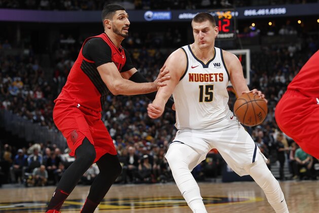 Denver Nuggets center Nikola Jokic, right, is defended by Portland Trail Blazers center Enes Kanter during the first half of Game 2 of an NBA basketball second-round playoff series Wednesday, May 1, 2019, in Denver. (AP Photo/David Zalubowski)