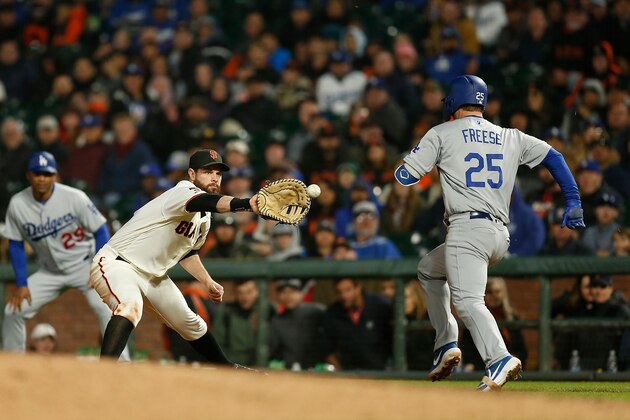 SAN FRANCISCO, CA - APRIL 30: First baseman Brandon Belt #9 of the San Francisco Giants gets the out of David Freese #25 of the Los Angeles Dodgers in the top of the seventh inning at Oracle Park on April 30, 2019 in San Francisco, California. (Photo by Lachlan Cunningham/Getty Images)