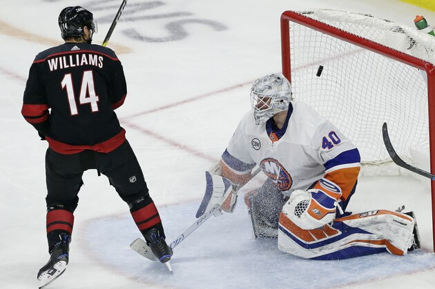 Carolina Hurricanes' Justin Williams (14) scores the game-winning goal against New York Islanders goalie Robin Lehner (40), of Sweden, during the third period of Game 3 of an NHL hockey second-round playoff series in Raleigh, N.C., Wednesday, May 1, 2019. Carolina won 5-2. (AP Photo/Gerry Broome)