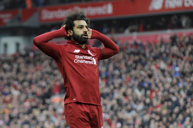 Liverpool's Mohamed Salah celebrates after scoring his side's second goal during the English Premier League soccer match between Liverpool and Chelsea at Anfield stadium in Liverpool, England, Sunday, April 14, 2019. (AP Photo/Rui Vieira)