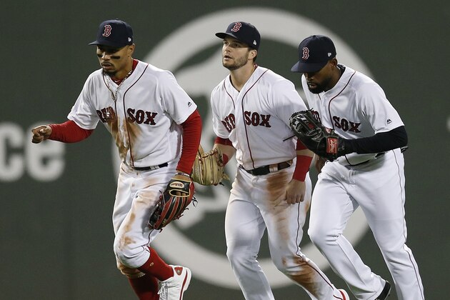 Boston Red Sox's Mookie Betts, left, Andrew Benintendi, center, and Jackie Bradley Jr. come in after defeating the Detroit Tigers during a baseball game in Boston, Thursday, April 25, 2019. (AP Photo/Michael Dwyer)