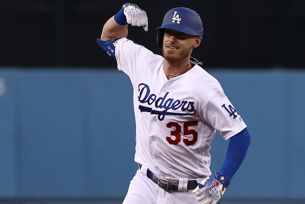 LOS ANGELES, CALIFORNIA - APRIL 26: Cody Bellinger #35 of the Los Angeles Dodgers flexes his muscle towards his teammates in the dugout as he rounds third base after hitting a two-run home run in the first inning during the MLB game against the Pittsburgh Pirates at Dodger Stadium on April 26, 2019 in Los Angeles, California. The Dodgers defeated the Pirates 6-2. (Photo by Victor Decolongon/Getty Images)