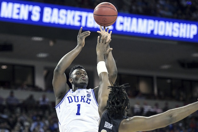 FILE - In this March 24, 2019, file photo, Duke forward Zion Williamson (1) attempts to shoot against Central Florida forward Chad Brown (21) during the first half of a second-round game in the NCAA men's college basketball tournament, in Columbia, S.C. Duke's Zion Williamson and R.J. Barrett are the second freshman teammates to earn first-team All-America honors.  Williamson and Barrett headed The Associated Press All-America team released on Tuesday, April 2, 2019, joined by Tennessee's Grant Williams, Murray State's Ja Morant and Cassius Winston of Michigan State. (AP Photo/Sean Rayford, File)