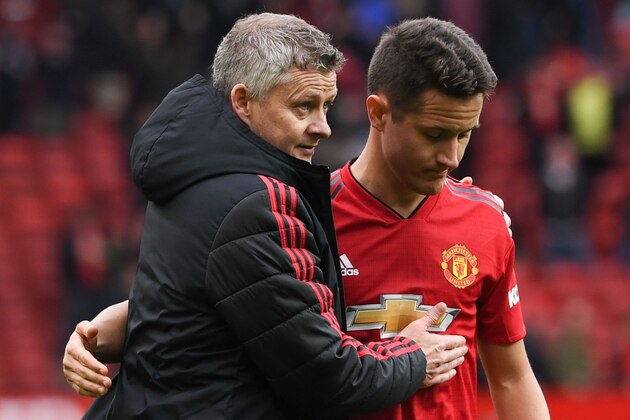 Manchester United's Norwegian manager Ole Gunnar Solskjaer (L) puts an arm around Manchester United's Spanish midfielder Ander Herrera (R) at the end of the English Premier League football match between Manchester United and Chelsea at Old Trafford in Manchester, north west England, on April 28, 2019. (Photo by Paul ELLIS / AFP) / RESTRICTED TO EDITORIAL USE. No use with unauthorized audio, video, data, fixture lists, club/league logos or 'live' services. Online in-match use limited to 120 images. An additional 40 images may be used in extra time. No video emulation. Social media in-match use limited to 120 images. An additional 40 images may be used in extra time. No use in betting publications, games or single club/league/player publications. /         (Photo credit should read PAUL ELLIS/AFP/Getty Images)