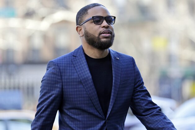 FILE - In this March 5, 2019, file photo, Christian Dawkins arrives at federal court in New York. A prosecutor says greed led a fledgling manager of basketball players to bribe college coaches but defense lawyers say it was all an FBI setup. The characterizations came during opening statements Tuesday, April 23, 2019, in the second trial to result from a prosecution that has exposed a seedy side of college basketball recruitment. On trial are business manager Christian Dawkins and ex-amateur league director Merl Code. (AP Photo/Seth Wenig, File)