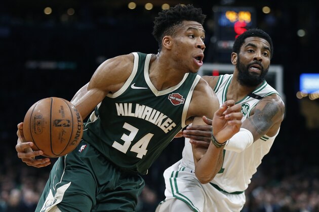 Milwaukee Bucks' Giannis Antetokounmpo (34) drives past Boston Celtics' Kyrie Irving during the first half of Game 3 of a second round NBA basketball playoff series in Boston, Friday, May 3, 2019. (AP Photo/Michael Dwyer)