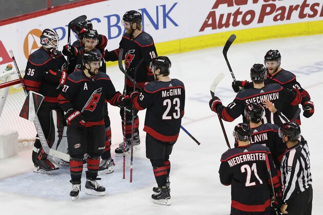 Carolina Hurricanes players celebrate following the team's win over the New York Islanders in Game 4 of an NHL hockey second-round playoff series in Raleigh, N.C., Friday, May 3, 2019. (AP Photo/Gerry Broome)