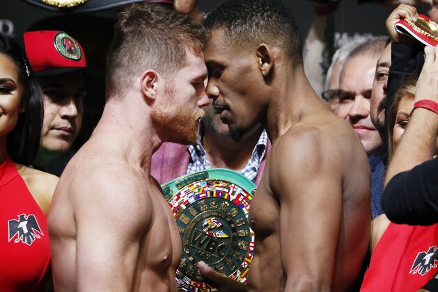 Canelo Alvarez, left, and Daniel Jacobs face off during a weigh-in for their middleweight title boxing match Friday, May 3, 2019, in Las Vegas. The two are scheduled to fight Saturday in Las Vegas. (AP Photo/John Locher)