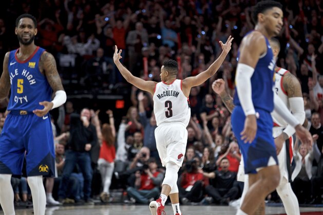Portland Trail Blazers guard CJ McCollum, center, reacts after making a three point basket against the Denver Nuggets during the second half of Game 3 of an NBA basketball second-round playoff series Friday, May 3, 2019, in Portland, Ore. (AP Photo/Craig Mitchelldyer)