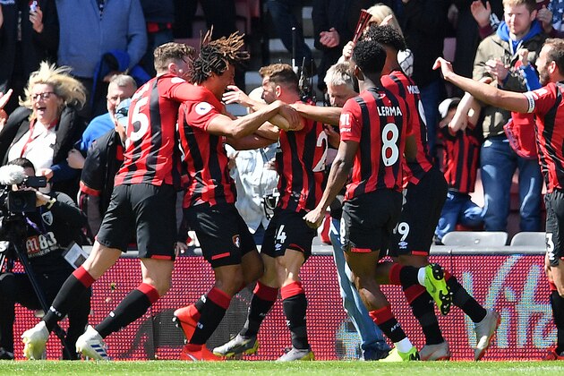 Bournemouth's Dutch defender Nathan Ake (2L) is mobbed by teammates after scoring the opening goal in the closing minutes of the English Premier League football match between Bournemouth and Tottenham Hotspur at the Vitality Stadium in Bournemouth, southern England on May 4, 2019. (Photo by Ben STANSALL / AFP) / RESTRICTED TO EDITORIAL USE. No use with unauthorized audio, video, data, fixture lists, club/league logos or 'live' services. Online in-match use limited to 120 images. An additional 40 images may be used in extra time. No video emulation. Social media in-match use limited to 120 images. An additional 40 images may be used in extra time. No use in betting publications, games or single club/league/player publications. /         (Photo credit should read BEN STANSALL/AFP/Getty Images)