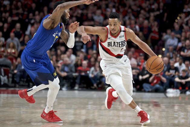 Portland Trail Blazers guard CJ McCollum, right, dribbles past Denver Nuggets guard Will Barton during the second half of Game 3 of an NBA basketball second-round playoff series Friday, May 3, 2019, in Portland, Ore. (AP Photo/Craig Mitchelldyer)