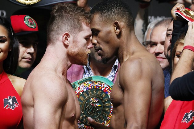 Canelo Alvarez, left, and Daniel Jacobs face off during a weigh-in for their middleweight title boxing match Friday, May 3, 2019, in Las Vegas. The two are scheduled to fight Saturday in Las Vegas. (AP Photo/John Locher)