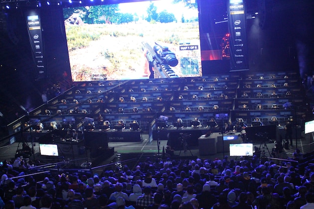 Fans watch as 80 players simultaneously fight for survival in an eSports match of upstart computer game PlayUnknown's Battlegrounds at an Intel Extreme Masters tournament in the Oracle Arena in Oakland, California on November 18, 2017.
Scores of virtual warriors faced-off in a Hunger Games-style death match here in a massive, real-world eSports match-up of upstart shooter game