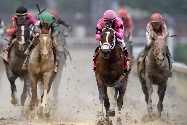CORRECTS MAXIMUM SECURITY DISQUALIFIED, ADDS WINNER COUNTRY HOUSE - Luis Saez rides Maximum Security to the finish line first during the 145th running of the Kentucky Derby horse race at Churchill Downs Saturday, May 4, 2019, in Louisville, Ky. Country House was declared the winner after Maximum Security was disqualified following a review by race stewards. (AP Photo/Darron Cummings)