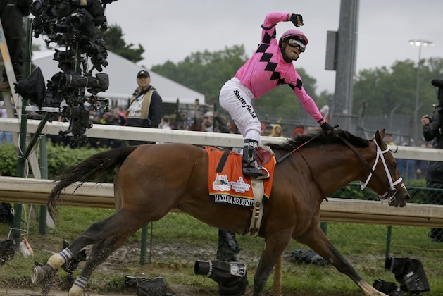 CORRECTS MAXIMUM SECURITY DISQUALIFIED, ADDS WINNER COUNTRY HOUSE - Luis Saez rides Maximum Security across the finish line first during the 145th running of the Kentucky Derby horse race at Churchill Downs Saturday, May 4, 2019, in Louisville, Ky. Country House was declared the winner after Maximum Security was disqualified following a review by race stewards. (AP Photo/Kiichiro Sato)
