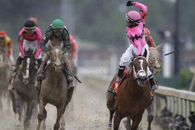 CORRECTS MAXIMUM SECURITY DISQUALIFIED, ADDS WINNER COUNTRY HOUSE - Luis Saez rides Maximum Security across the finish line first during the 145th running of the Kentucky Derby horse race at Churchill Downs Saturday, May 4, 2019, in Louisville, Ky. Country House was declared the winner after Maximum Security was disqualified following a review by race stewards. (AP Photo/Darron Cummings)