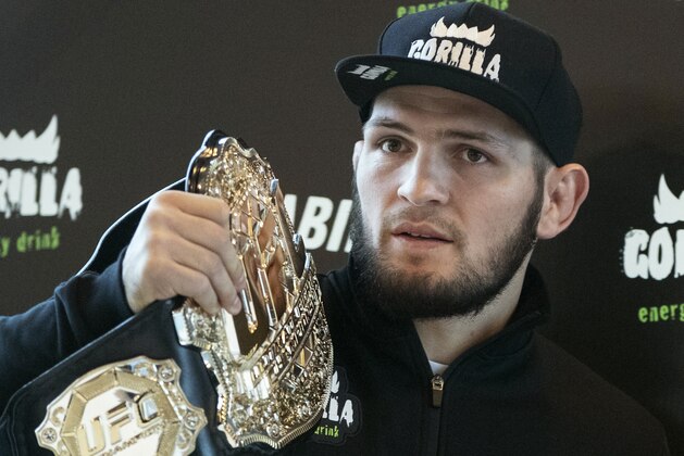 UFC lightweight champion Khabib Nurmagomedov holds the trophy belt during a news conference in Moscow, Russia, Monday, Nov. 26, 2018. The Russian professional mixed martial arts fighter Nurmagomedov, said he can imagine a reconciliation with Conor McGregor after the bitter feud around last month's title fight, but said he would like to fight Floyd Mayweather Jr. (AP Photo/Pavel Golovkin)