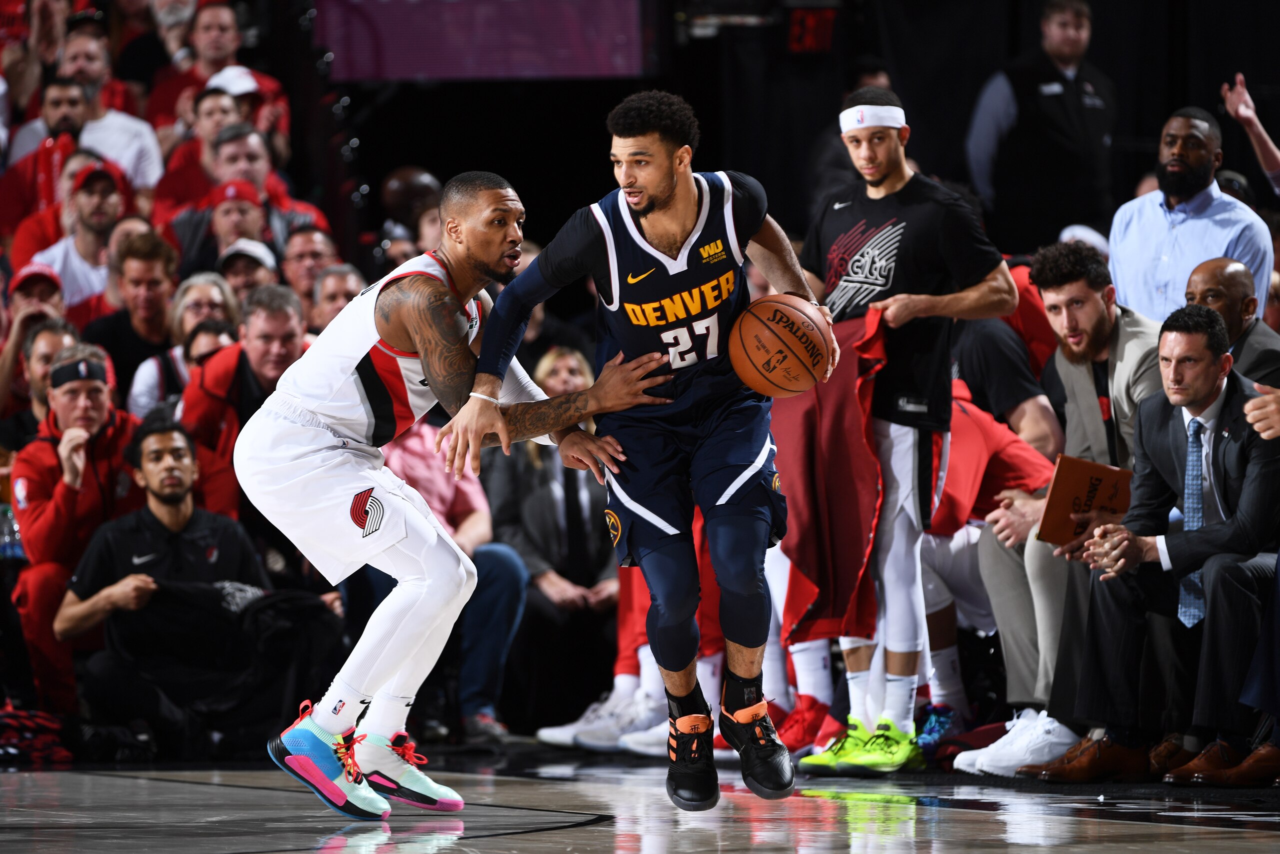 PORTLAND, OR - MAY 5: Jamal Murray #27 of the Denver Nuggets handles the ball against Damian Lillard #0 of the Portland Trail Blazers during Game Four of the Western Conference Semifinals on May 5, 2019 at the Moda Center Arena in Portland, Oregon. NOTE TO USER: User expressly acknowledges and agrees that, by downloading and or using this photograph, user is consenting to the terms and conditions of the Getty Images License Agreement. Mandatory Copyright Notice: Copyright 2019 NBAE (Photo by Garrett Ellwood/NBAE via Getty Images)