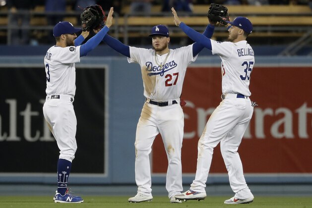 From left, Los Angeles Dodgers' Chris Taylor, Alex Verdugo (27) and Cody Bellinger (35) celebrate after a win over the Pittsburgh Pirates during a baseball game, Saturday, April 27, 2019, in Los Angeles. (AP Photo/Marcio Jose Sanchez)