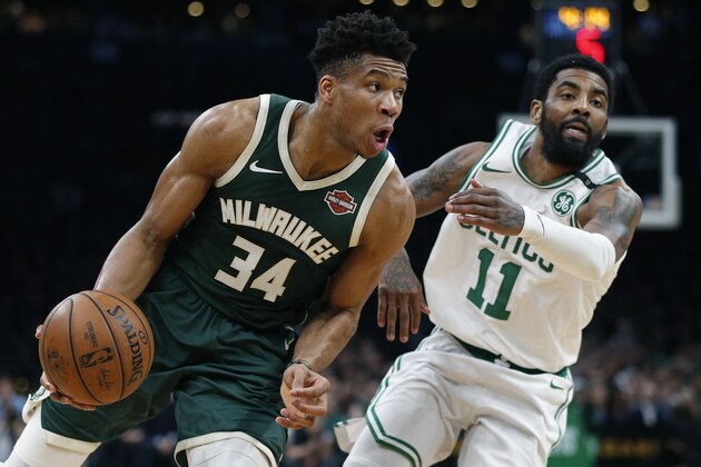 Milwaukee Bucks' Giannis Antetokounmpo (34) drives past Boston Celtics' Kyrie Irving during the first half of Game 3 of a second round NBA basketball playoff series in Boston, Friday, May 3, 2019. (AP Photo/Michael Dwyer)