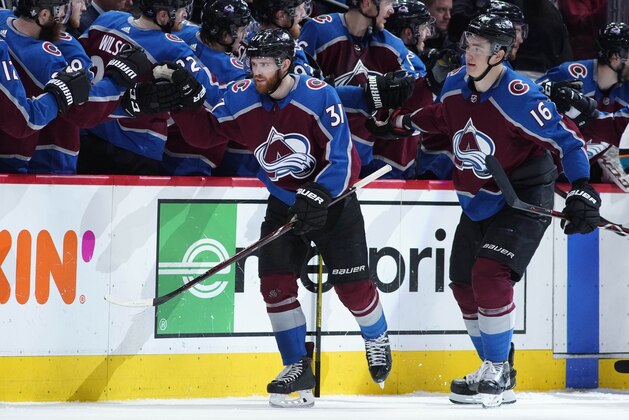 Colorado Avalanche left wing J.T. Compher, front left, is congratulated after scoring a goal as he passes the team box with defenseman Nikita Zadorov in the second period of Game 6 of an NHL hockey second-round playoff series against the San Jose Sharks, Monday, May 6, 2019, in Denver. (AP Photo/Jack Dempsey)