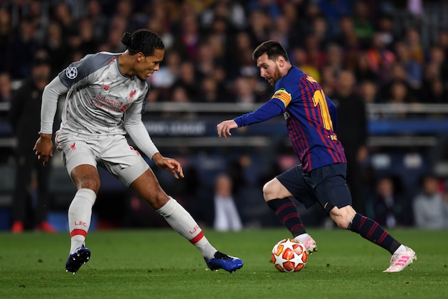 BARCELONA, SPAIN - MAY 01: Lionel Messi of FC Barcelona and Virgil Van Dijk of Liverpool compete for the ball during the UEFA Champions League Semi Final first leg match between Barcelona and Liverpool at the Nou Camp on May 1, 2019 in Barcelona, Spain. (Photo by Etsuo Hara/Getty Images)
