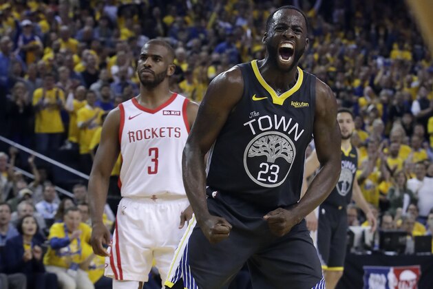 Golden State Warriors' Draymond Green (23) reacts after scoring, in front of Houston Rockets' Chris Paul (3) during the second half of Game 2 of a second-round NBA basketball playoff series in Oakland, Calif., Tuesday, April 30, 2019. (AP Photo/Jeff Chiu)
