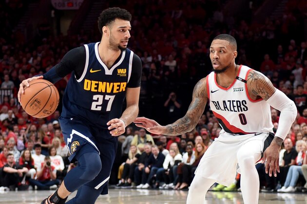 PORTLAND, OREGON - MAY 05: Jamal Murray #27 of the Denver Nuggets drives to the basket on Damian Lillard #0 of the Portland Trail Blazers during the second half of game four of the Western Conference Semifinals at Moda Center on May 05, 2019 in Portland, Oregon. The Nuggets won 116-112. NOTE TO USER: User expressly acknowledges and agrees that, by downloading and or using this photograph, User is consenting to the terms and conditions of the Getty Images License Agreement. (Photo by Steve Dykes/Getty Images)