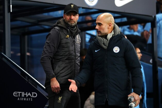 MANCHESTER, ENGLAND - JANUARY 03: Josep Guardiola, Manager of Manchester City walks away from Jurgen Klopp, Manager of Liverpool prior to the Premier League match between Manchester City and Liverpool FC at the Etihad Stadium on January 3, 2019 in Manchester, United Kingdom.  (Photo by Clive Brunskill/Getty Images)